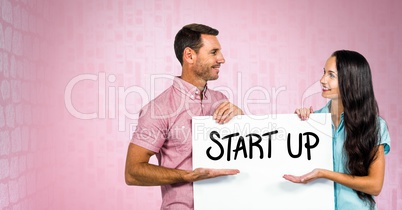 Business people holding bill board with start up text on it