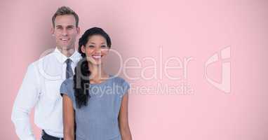 Portrait of smiling casual business people over pink background