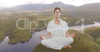 Double exposure man meditating on mountain by river