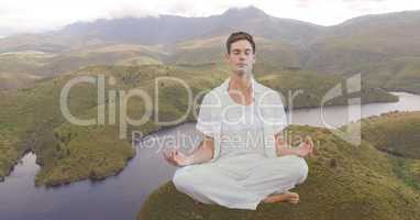 Double exposure man meditating on mountain by river