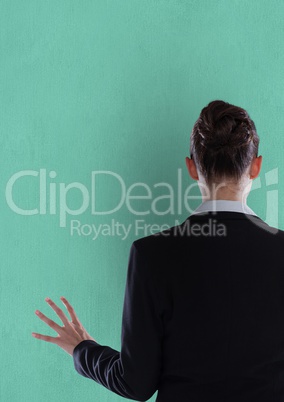 Rear view of businesswoman over green background