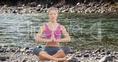 Double exposure of woman meditating at lake shore