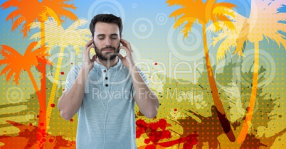 Young man listening to music through earphones