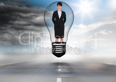 Businesswoman in light bulb over road