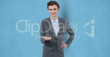 Smiling businesswoman gesturing over blue background