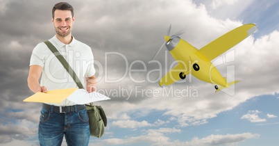 Delivery man giving parcel with airplane in background