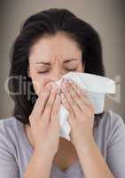 Woman crying into tissue against brown background