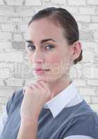 Close up of business woman thinking against white brick wall
