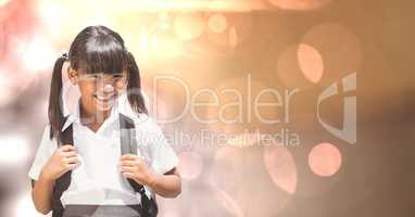 Schoolgirl smiling over bokeh