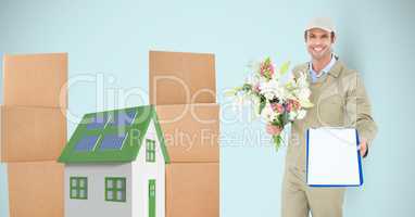 Delivery man showing clipboard while holding flowers by parcels and 3d house