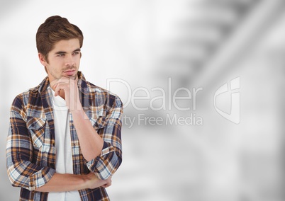 Thoughtful male hipster standing with hand on chin