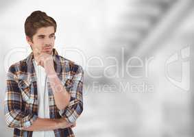 Thoughtful male hipster standing with hand on chin