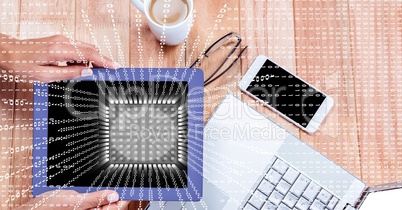 Businesswoman holding digital tablet at desk with overlay