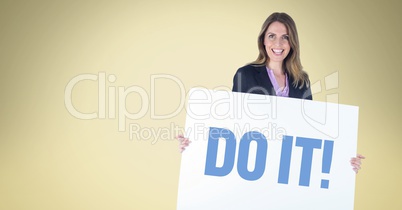 Confident businesswoman holding placard with do it sign