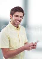 Portrait of smiling male hipster holding smart phone