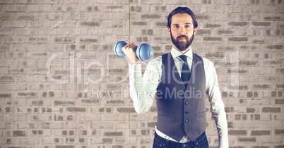 Hipster lifting dumbbells against wall