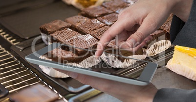 Hand photographing brownie through tablet PC
