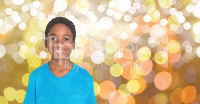 Portrait of smiling boy standing over bokeh