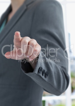 Midsection of businesswoman touching imaginary screen