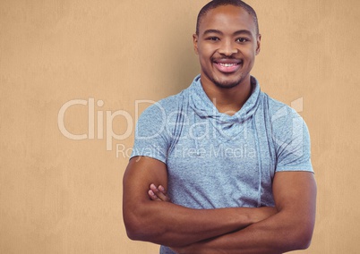 Portrait of confident male hipster standing arms crossed against orange background