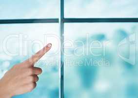 Hand pointing in air by window