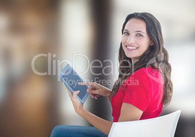 Portrait of woman smiling while using tablet PC