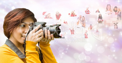 Female photographer using SLR camera by flying Christmas portraits
