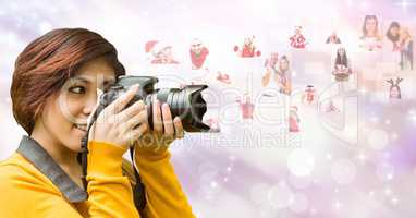 Female photographer using SLR camera by flying Christmas portraits