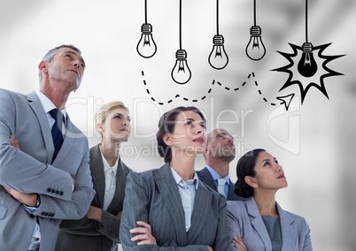 Business people looking at lightbulb graphic against blurry grey stairs