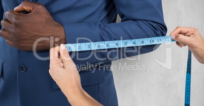 Hand measuring sleeve of businessman
