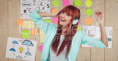 Redhead woman dancing while listening to music on headphones against graphics
