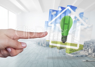 Hand touching a Home with green energy lightbulb