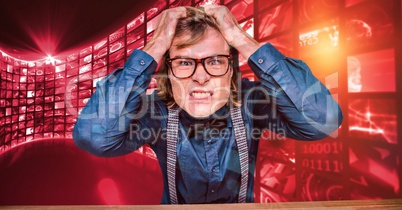 Frustrated hipster pulling hair against screen