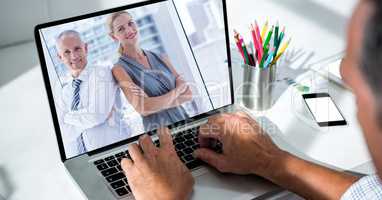 Cropped image of businessman video conferencing in office