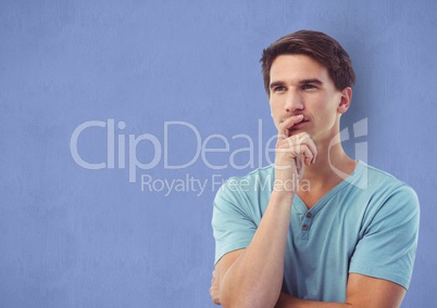 Thoughtful male hipster against blue background