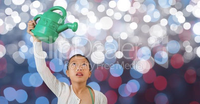 Little girl holding watering can over blur background