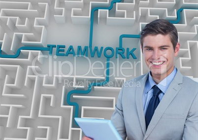 Businessman holding tablet PC while teamwork text connected in maze