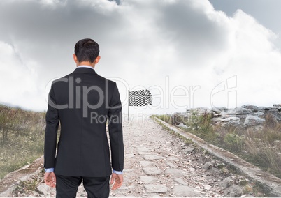 businessman in a road going to catch the checker flag
