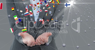 Midsection of businessman with cupped hands and various flags