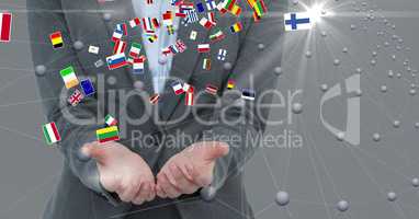 Midsection of businessman with cupped hands and various flags
