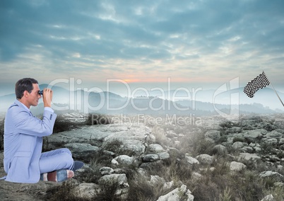 businessman sit in the floor with binoculars looking the checker flag