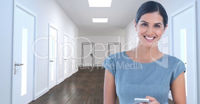 Smiling businesswoman with mobile phone in office