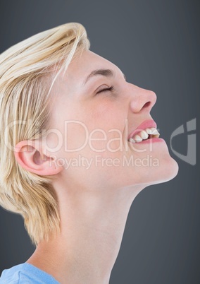 Close up profile of woman eyes closed against grey background