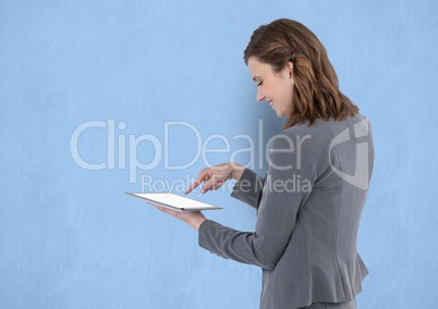 Businesswoman touching on blank screen of tablet PC over blue background