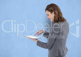 Businesswoman touching on blank screen of tablet PC over blue background