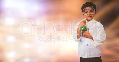 Portrait of boy doing scientific experiment over blur background