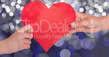 Cropped image of hands holding heart shape over  bokeh