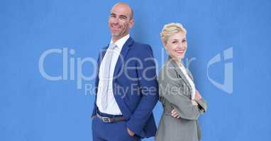 Portrait of confident business people standing against blue background