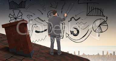 Rear view of businessman drawing graphics on roof