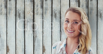 Portrait of confident businesswoman against wooden wall